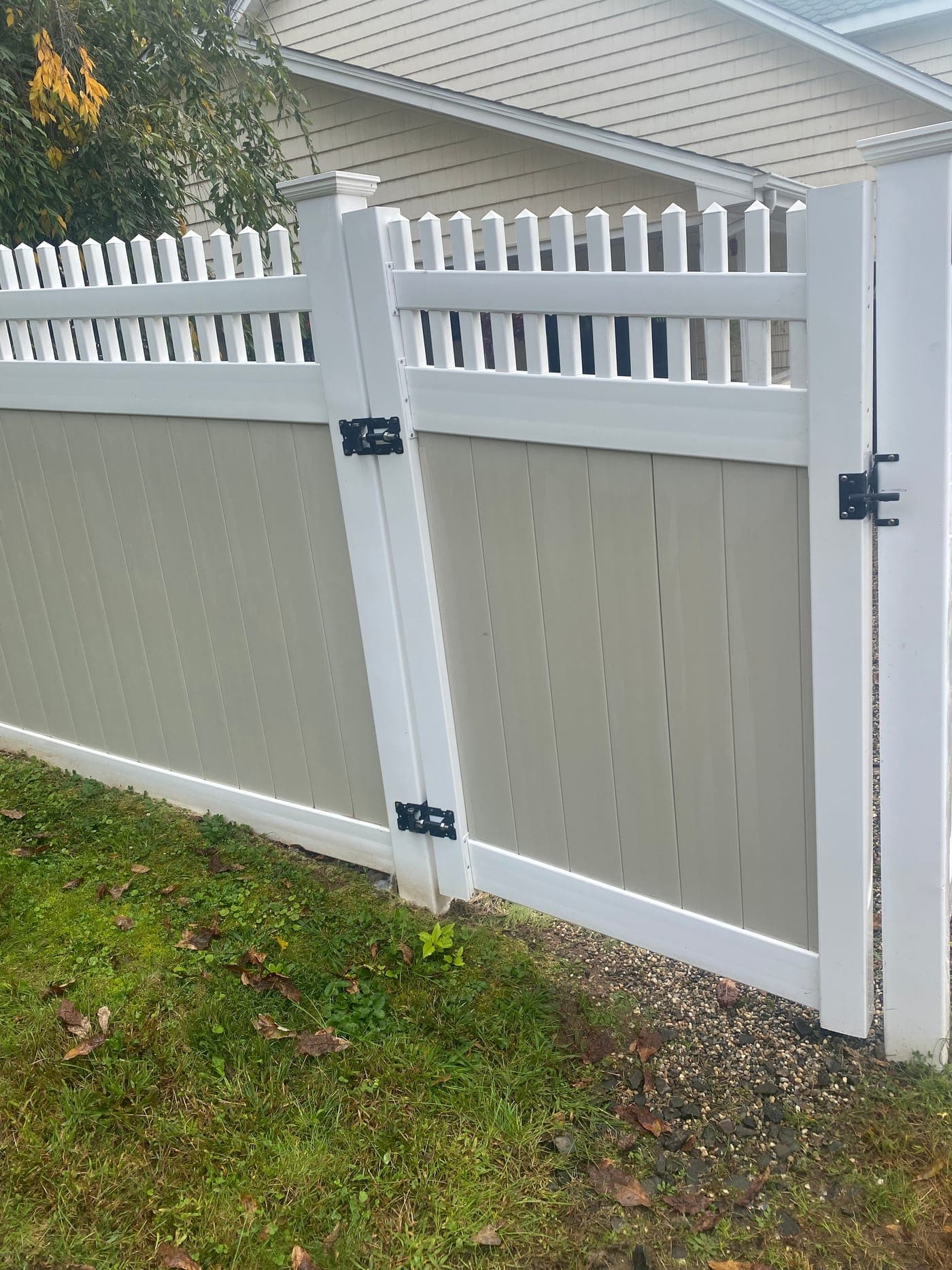 White vinyl fence restored to bright clean finish after power washing