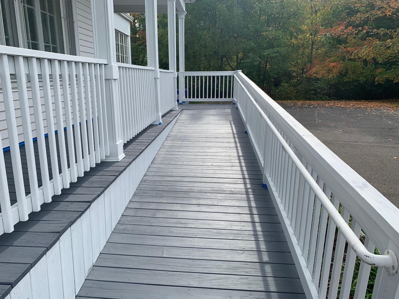 Gray painted porch with white railings side view