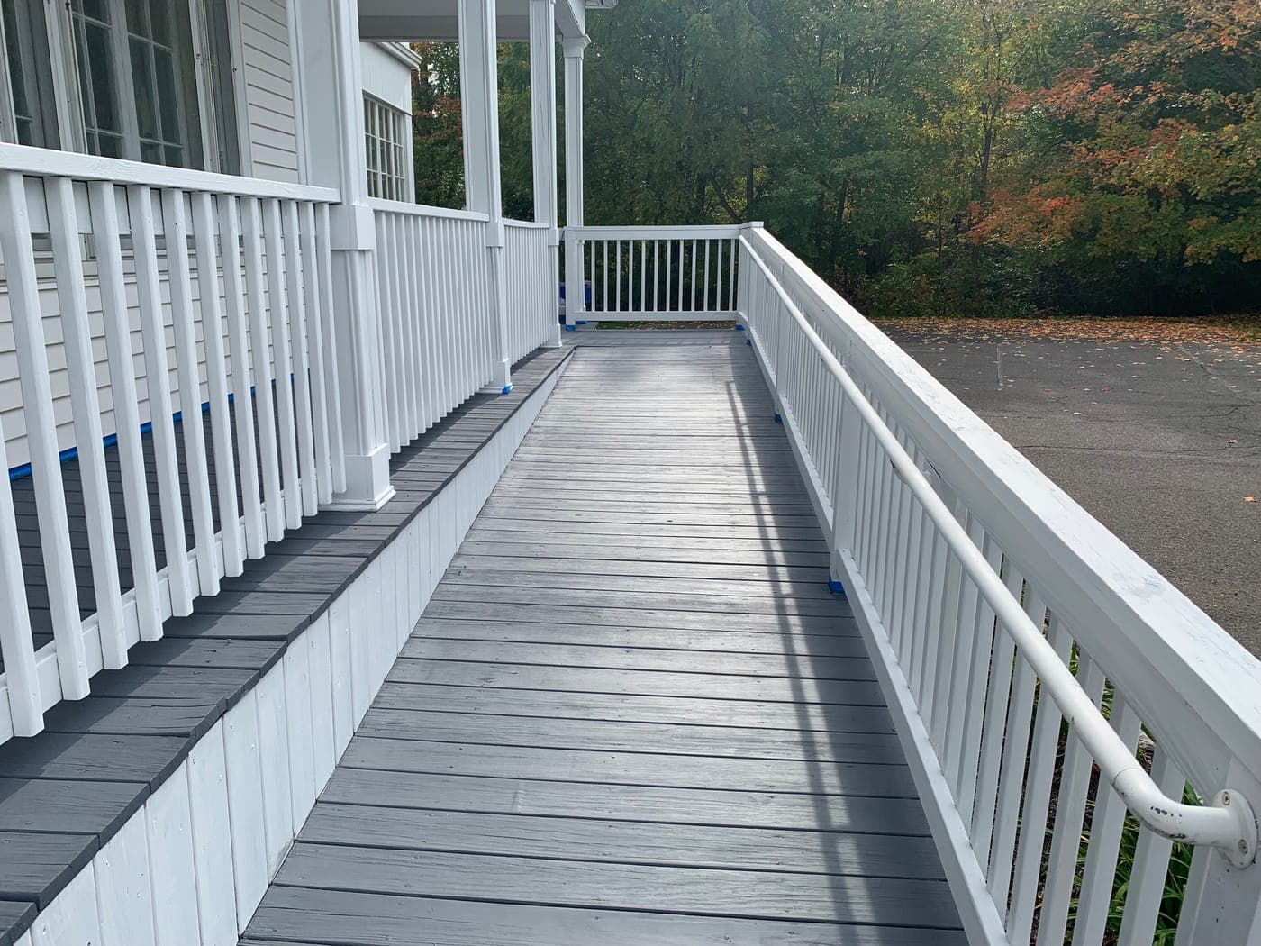 Gray painted porch with white railings side view